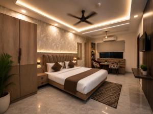 a bedroom with a large bed and a living room at Aaditri Inn in Gorakhpur