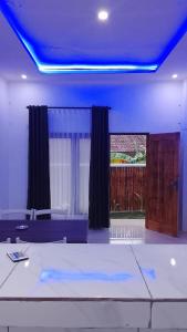 a living room with a blue ceiling at USTIN Villas Lombok in Bumbang