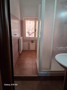 a bathroom with a sink and a toilet and a window at Le Ortensie in Bono +65 photos