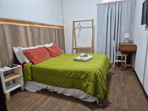 a bedroom with a bed with a green comforter at Hotel Lincoln Rooms in Lincoln +45 photos