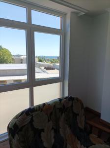 a couch in a room with a large window at Refugio Mar de Boiro in Boiro
