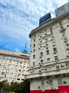a large white building with a sign on top of it at Iconic Obelisco Studio in Buenos Aires