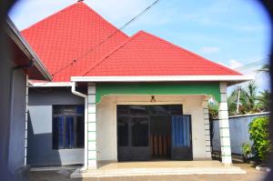 a house with an orange roof with a garage at Brabus Appartment Motel in Rubavu