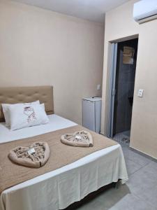a bedroom with a bed with towels on it at Pousada Mar de Pajuçara in Maceió