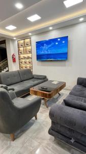 a living room with two couches and a tv at Zarina Hotels & Hamam in Batumi