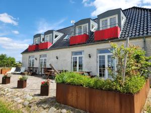 a large house with red shutters on it at Roskilde B&B in Gadstrup