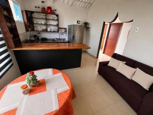 a living room with a table and a couch at Hospedaje Isabela in Puerto Villamil