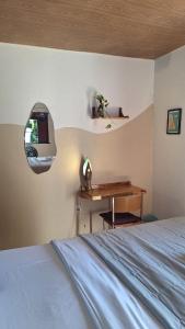 a bedroom with a bed and a wooden desk at Pipa Centro in Pipa +21 photos