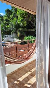 a hammock on the balcony of a house at Pipa Centro in Pipa