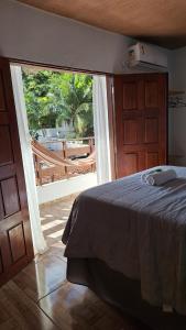 a bedroom with a bed and a large window at Pipa Centro in Pipa