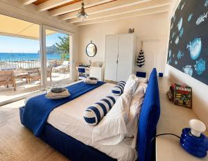 a bedroom with a large bed with a view of the ocean at Il Profumo del Mare GuestHouse in Cagliari