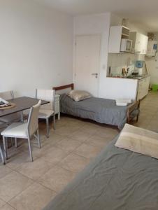 a room with a table and a bed and a table and chairs at Hotel Lincoln Rooms in Lincoln