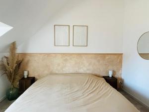 a bedroom with a bed with two pictures on the wall at Gîte grand confort 15 personnes - Le Domaine - Wimereux in Wimereux +21 photos