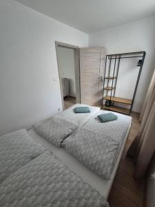 a bedroom with a large bed and a mirror at Apartamenty Kaszubski Przystanek in Luzino