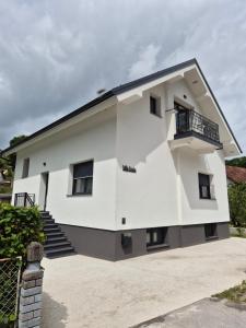 a white house with a black roof at Villa Freska in Rogaška Slatina