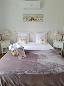 a bedroom with a large bed with a book on it at Ker'mima in Antoigné Châtellerault in Châtellerault