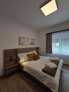 a bedroom with a large bed and a window at Villa Freska in Rogaška Slatina