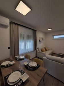 a living room with a dining table and a couch at Villa Freska in Rogaška Slatina