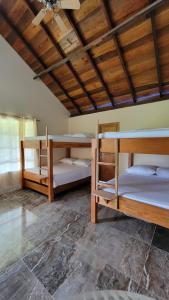 a room with three bunk beds in it at Cocoloco's Lodge in El Valle