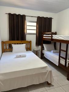 two beds in a room with two bunk beds at Casa Zago 1 in Santa Maria Madalena