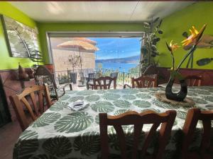 a dining room with a table and a view of the ocean at Casa baja a la playa in Bueu