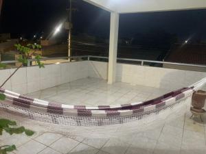 a hammock on top of a building at night at Quartos petrolina 02 in Petrolina