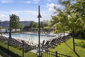 a swimming pool with chairs and a fence at Sunny Getaway at Veranda Beach in Oroville