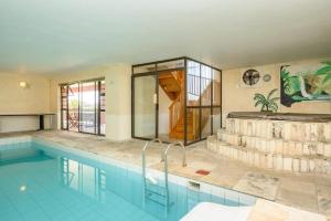 a large swimming pool in a house at Diamond Style Guesthouse in Gqeberha