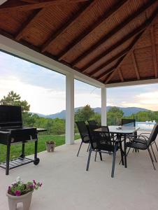 a patio with a piano and a table and chairs at Vila Lana in Trebinje
