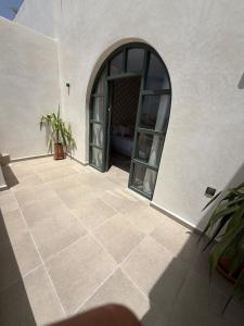 a room with a door and a tile floor at HoneyPath Ocean Retreat in Tamraght Ouzdar +37 photos