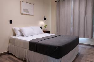 a bedroom with a large bed and a window at Hotel Casa Arbórea in San José +19 photos