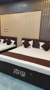 two beds with brown and white pillows on them at Ma jamwanti homestay in Ayodhya +14 photos