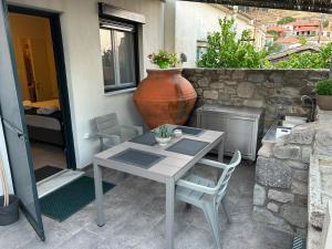 a table and chairs on a patio with a vase at Lemnos Nest in Kondiás