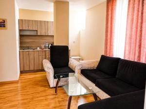 a living room with a couch and a table at Liora studio apartments in Sunny Beach