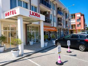 a car parked in a parking lot in front of a hotel at Liora studio apartments in Sunny Beach