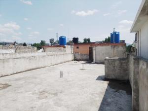 an empty rooftop of a building with blue tanks at Spacious 2 Bed Room Home Attached Baths, Lounge & Kitchen in Abbottabad