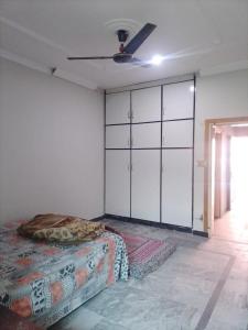 a bedroom with a bed and a large closet at Spacious 2 Bed Room Home Attached Baths, Lounge & Kitchen in Abbottabad