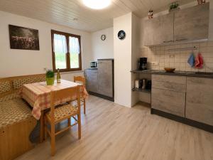 a kitchen and dining room with a table and a table and chairs at Bad Hindelang in Bad Hindelang
