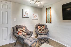 two chairs sitting in a room with a tv at Work, Play & Explore w/ Ease! Dtwn Meridian Apt in Meridian