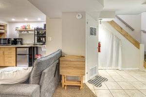 a living room with a couch and a kitchen at Work, Play & Explore w/ Ease! Dtwn Meridian Apt in Meridian