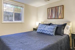 a bedroom with a blue bed with a window at Work, Play & Explore w/ Ease! Dtwn Meridian Apt in Meridian