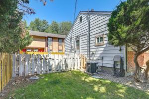 a white house with a fence next to a yard at Work, Play & Explore w/ Ease! Dtwn Meridian Apt in Meridian