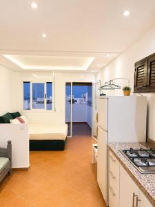 a kitchen and living room with a bed and a refrigerator at STUDIO FOR 3 PERSON & ANOTHER FOR 4 PERSON - MIRAMAR MARTIL ll in Martil