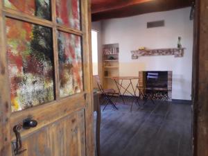 a door in a room with a table and a fireplace at Nuit pour 2 en Auvergne in Vallon-en-Sully