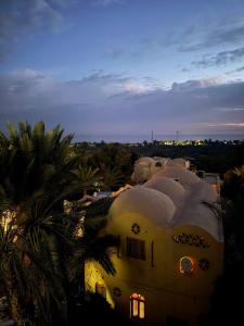 a building with snow on top of it at night at Rahma House Hostel in Tunis