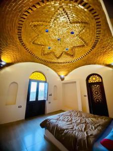 a bedroom with a bed and a large chandelier at Rahma House Hostel in Tunis