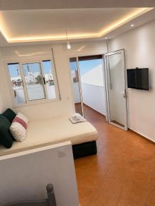 a small room with a bed and a flat screen tv at STUDIO FOR 3 PERSON & ANOTHER FOR 4 PERSON - MIRAMAR MARTIL ll in Martil