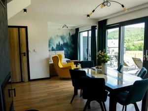 a dining room with a table and chairs at Domek Veron in Wysowa-Zdrój