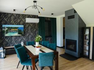a dining room with a table and chairs and a fireplace at Domek Veron in Wysowa-Zdrój