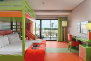 a bedroom with a bunk bed with a desk and a desk at Vila Galé Collection Sunset Cumbuco in Cumbuco +96 photos